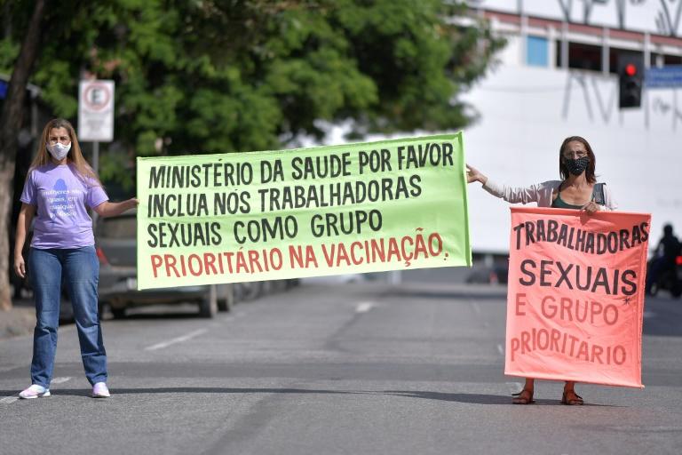 Sex workers protest at Rua Guaicurus, in Belo Horizonte, in Brazil's Minas Gerais state on April 5, 2021, asking to be considered a priority group to receive the vaccine against Covid-19