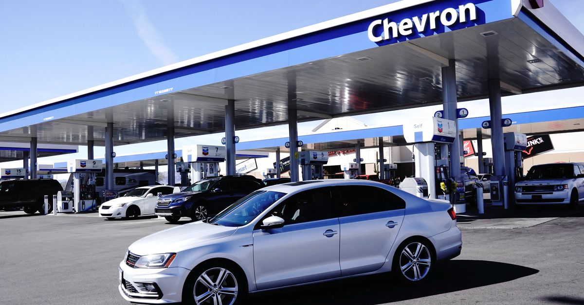 Exxon, Chevron split over how to manage rising cash piles